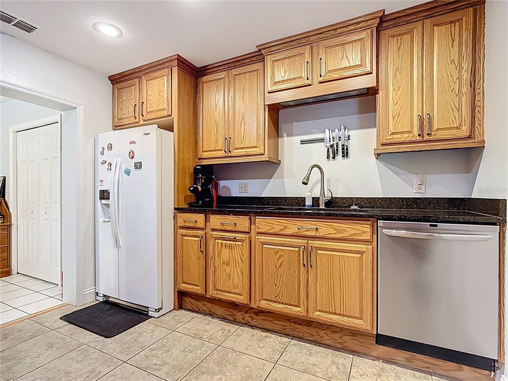 1405 East Clinton Street Bartow, FL 33830 - Photo 14 of 25 a kitchen with stainless steel appliances granite countertop a refrigerator and a sink