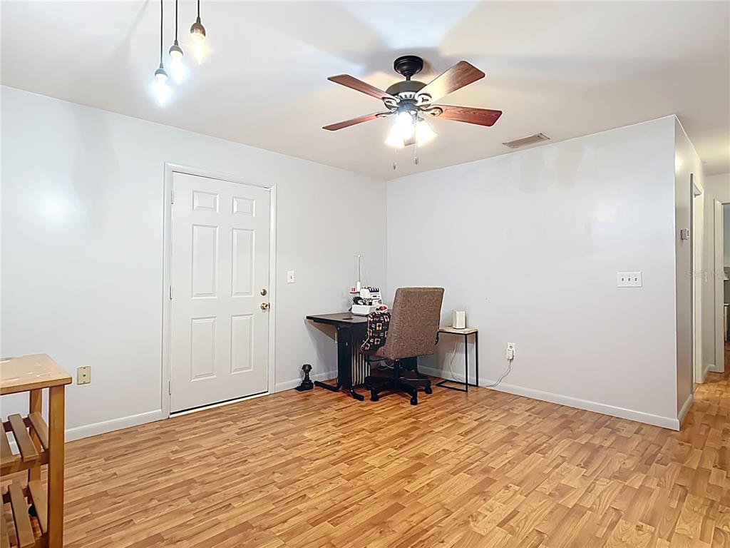 1405 East Clinton Street Bartow, FL 33830 - Photo 16 of 25 a view of a workspace with furniture and wooden floor
