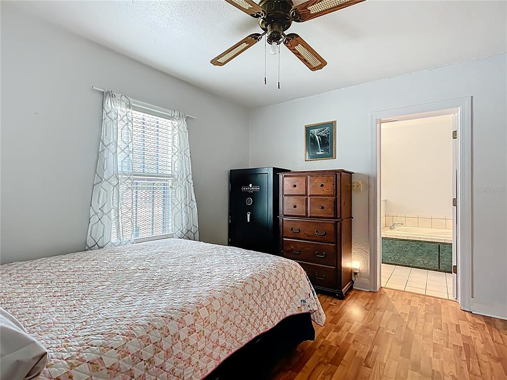 1405 East Clinton Street Bartow, FL 33830 - Photo 6 of 25 a bedroom with a bed and wooden floor