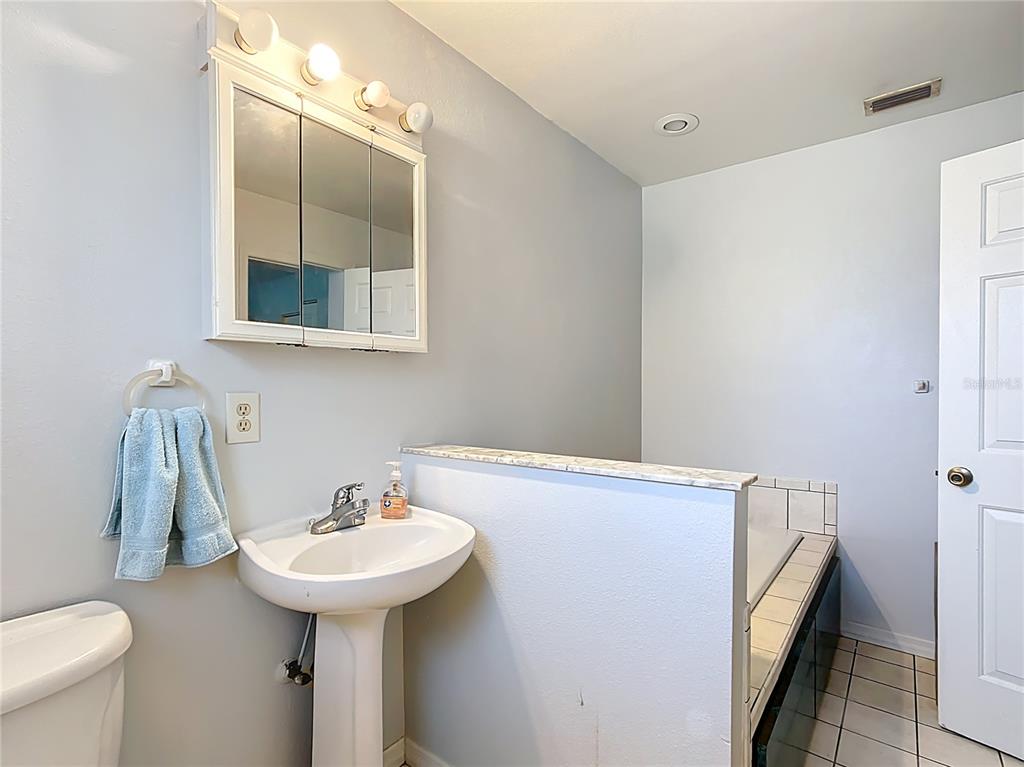 1405 East Clinton Street Bartow, FL 33830 - Photo 8 of 25 a bathroom with a sink and a toilet