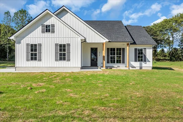 a front view of a house with a garden