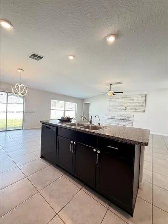 an empty room with closet and windows