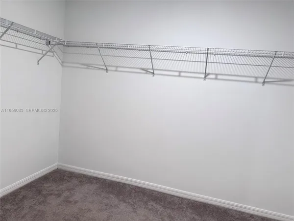 a spacious bathroom with a vanity a sink a mirror and a bathtub