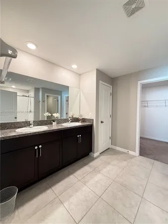 an empty room with a window and a ceiling fan