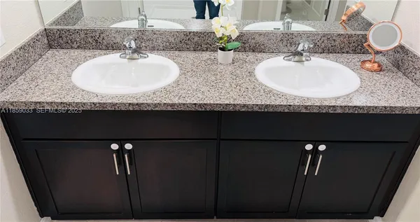 an empty room with closet and windows