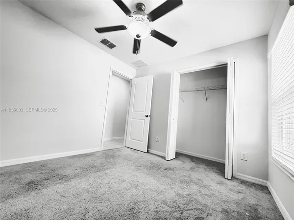 a utility room with cabinets washer and dryer