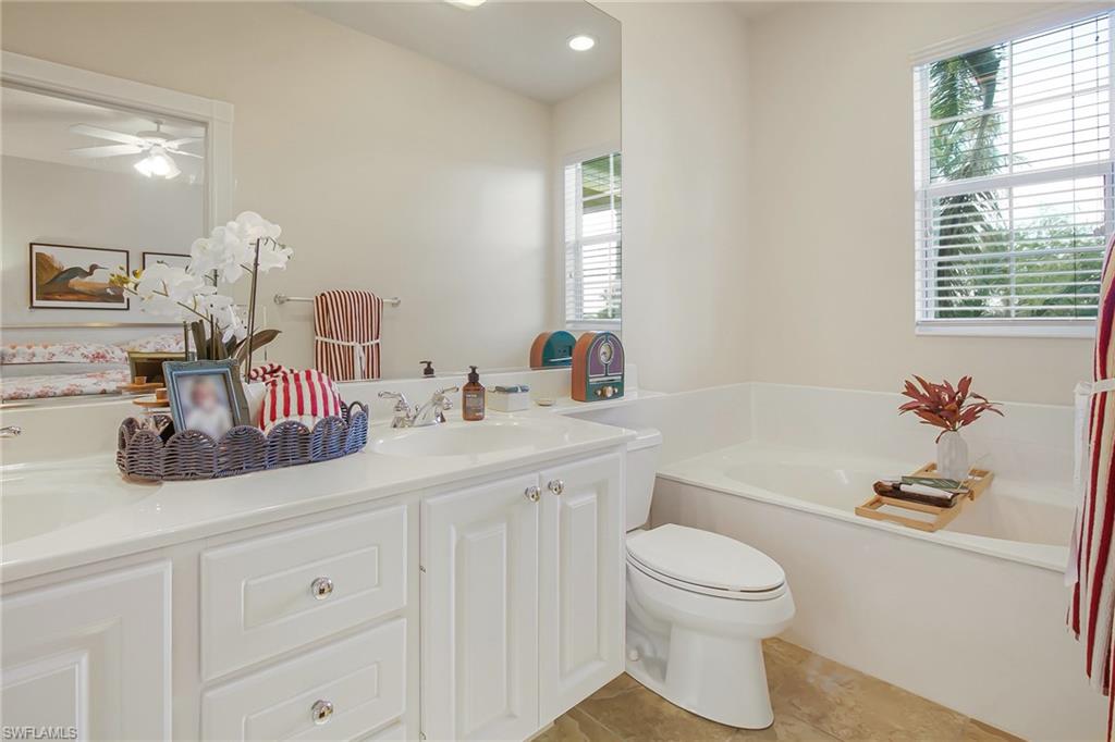 7201 Bellini Way Naples, FL 34114 - Photo 16 of 39 a bathroom with a sink a toilet and a bathtub
