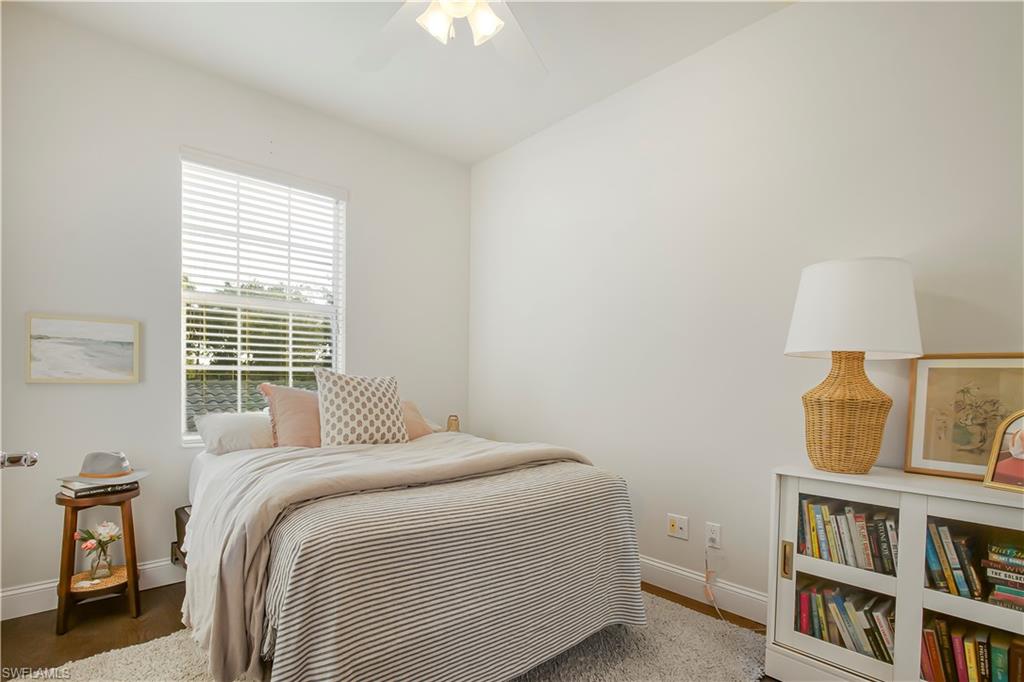 7201 Bellini Way Naples, FL 34114 - Photo 20 of 39 a bedroom with a bed and a book shelf