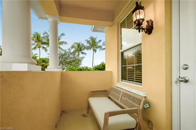 a balcony with table and chairs