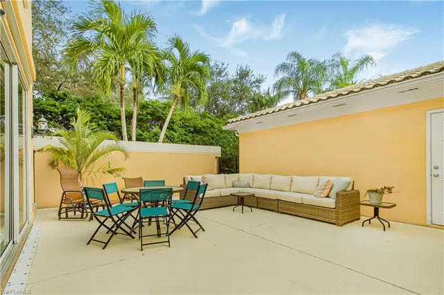 a balcony with table and chairs