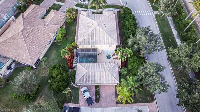 an aerial view of a house with outdoor space and lake view