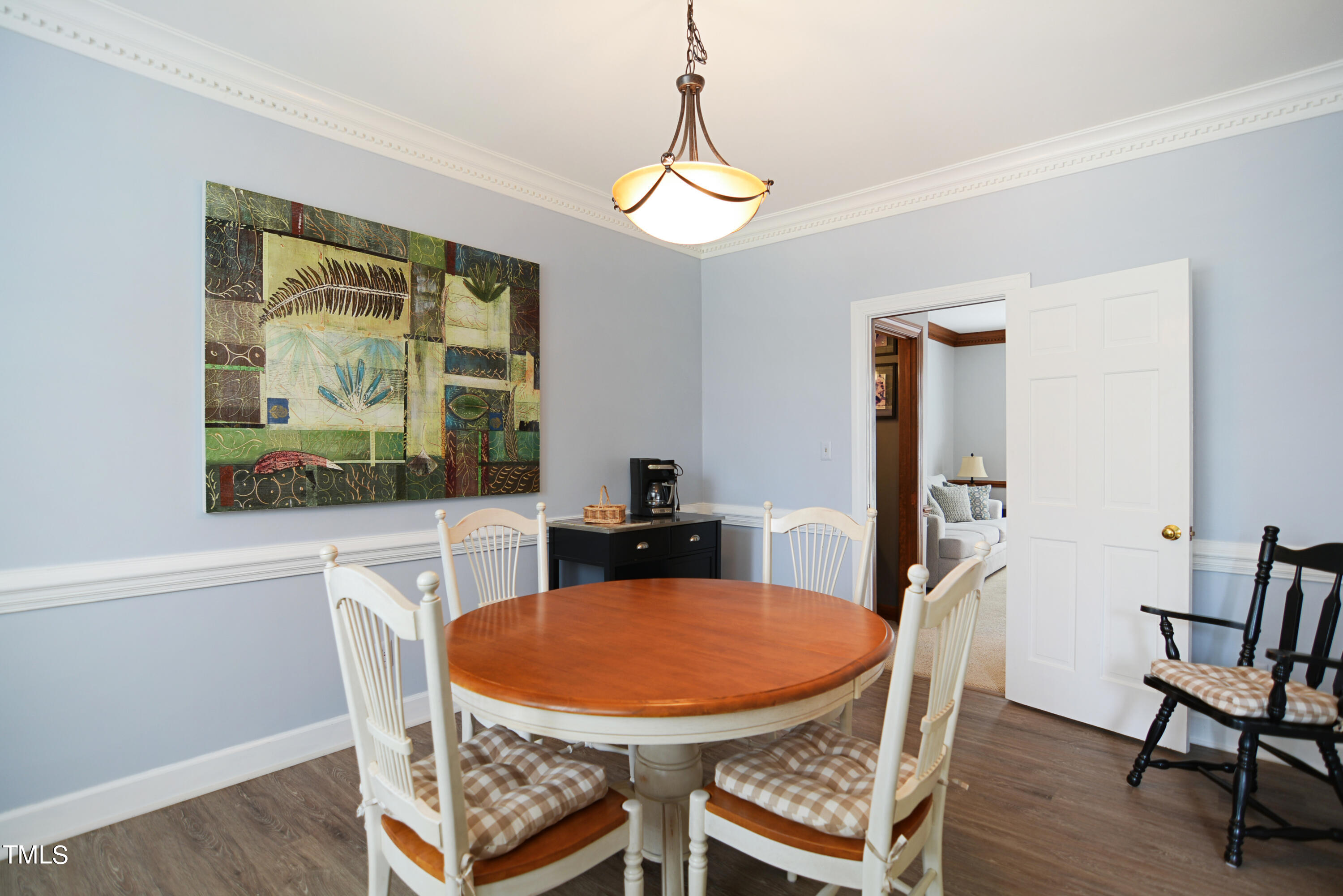 1811 Carrington Drive Raleigh, NC 27615 - Photo 8 of 23 a view of a dining room with furniture window and wooden floor