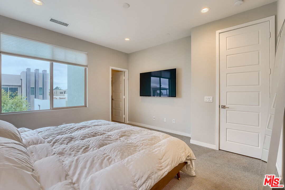 237 Magnet Irvine, CA 92618 - Photo 14 of 34 a bedroom with a bed and a window