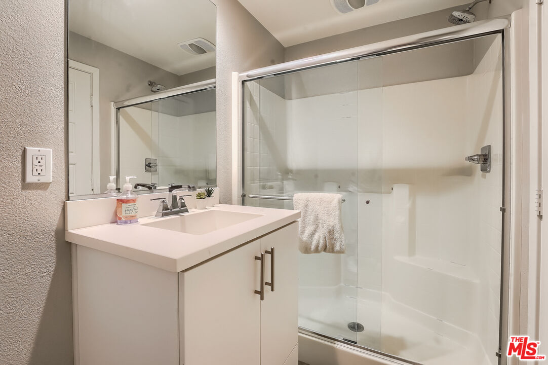 237 Magnet Irvine, CA 92618 - Photo 22 of 34 a bathroom with a sink mirror and a shower