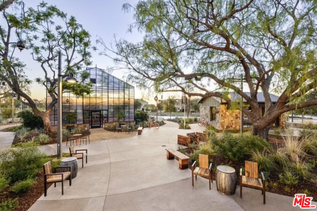 237 Magnet Irvine, CA 92618 - Photo 29 of 34 a view of a patio with dining table and chairs with wooden fence and large trees