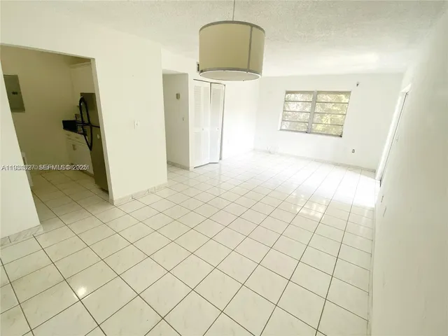 a view of a livingroom with wooden floor and a window