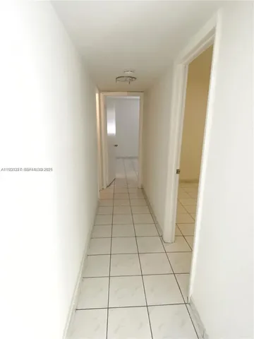 a view of a livingroom with an empty space and a window