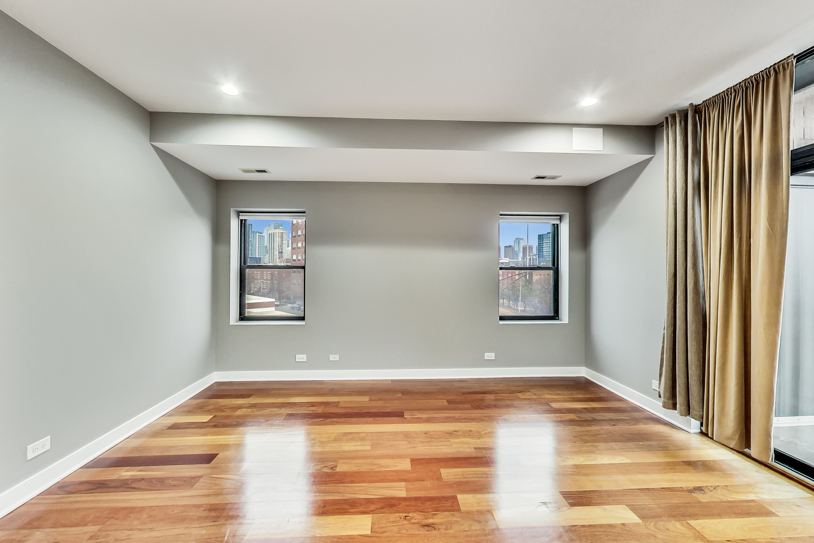 651 North Milwaukee Avenue, Unit 304 Chicago, IL 60642 - Photo 13 of 33 wooden floor in an empty room with a window