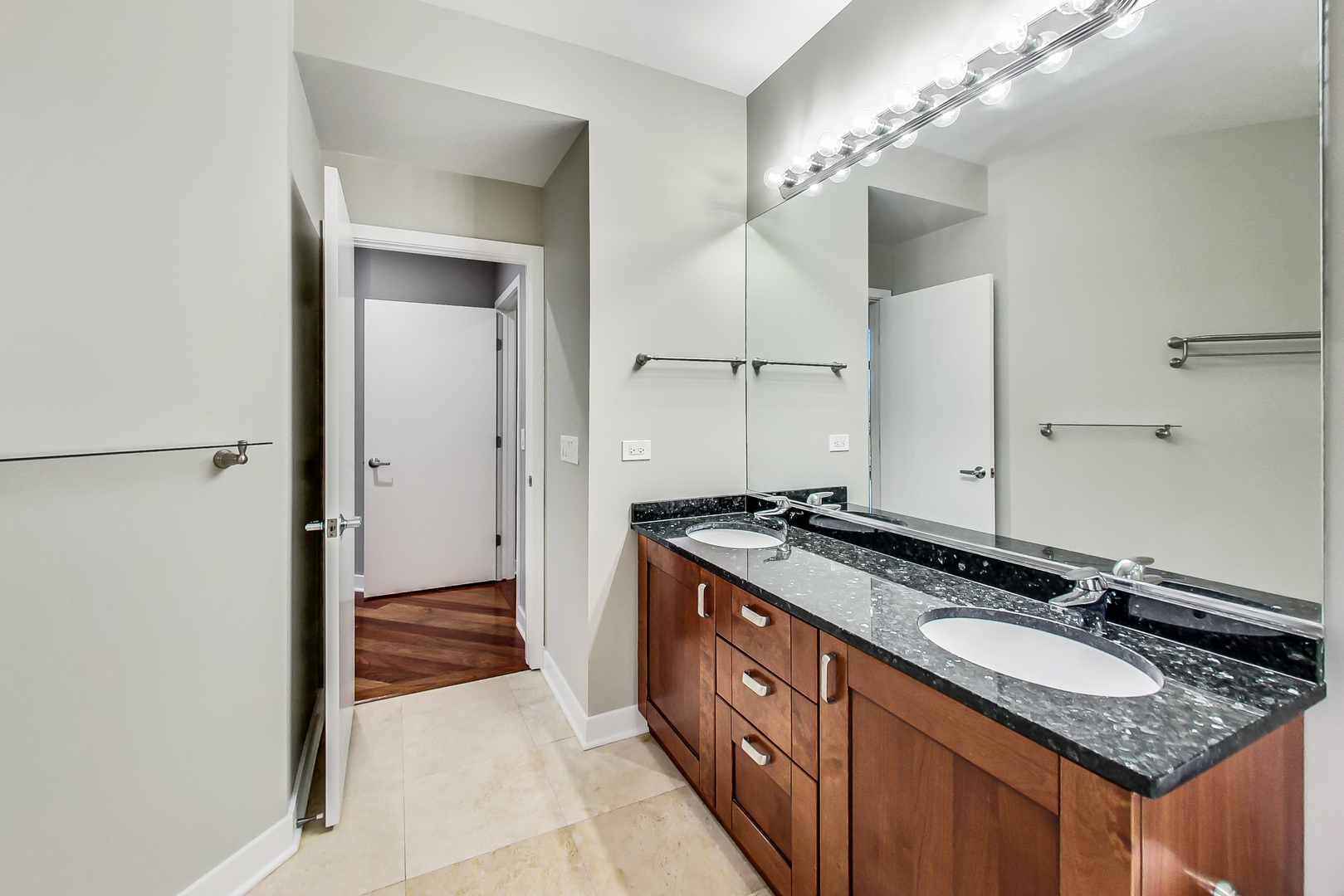 651 North Milwaukee Avenue, Unit 304 Chicago, IL 60642 - Photo 18 of 33 a spacious bathroom with a granite countertop sink and a mirror