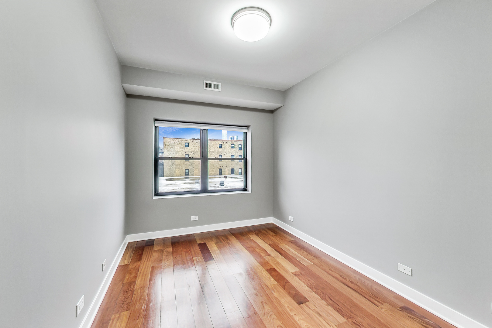 651 North Milwaukee Avenue, Unit 304 Chicago, IL 60642 - Photo 23 of 33 an empty room with wooden floor and windows