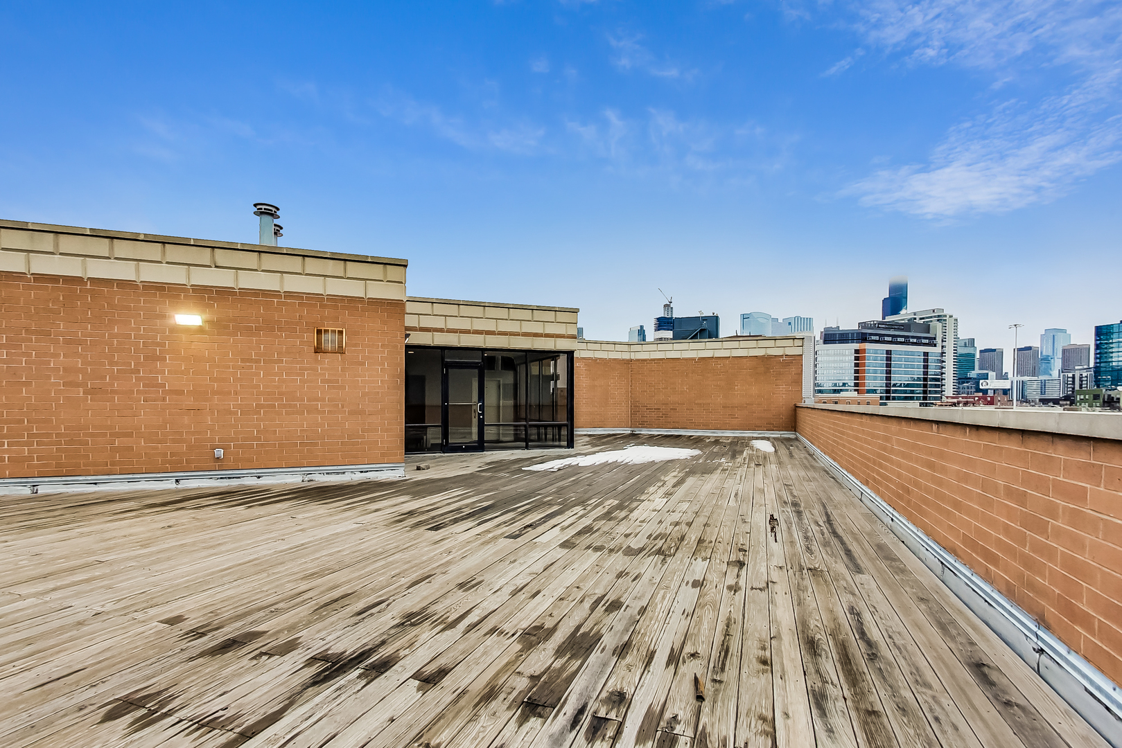 651 North Milwaukee Avenue, Unit 304 Chicago, IL 60642 - Photo 31 of 33 a view of a terrace with wooden floor and a fireplace
