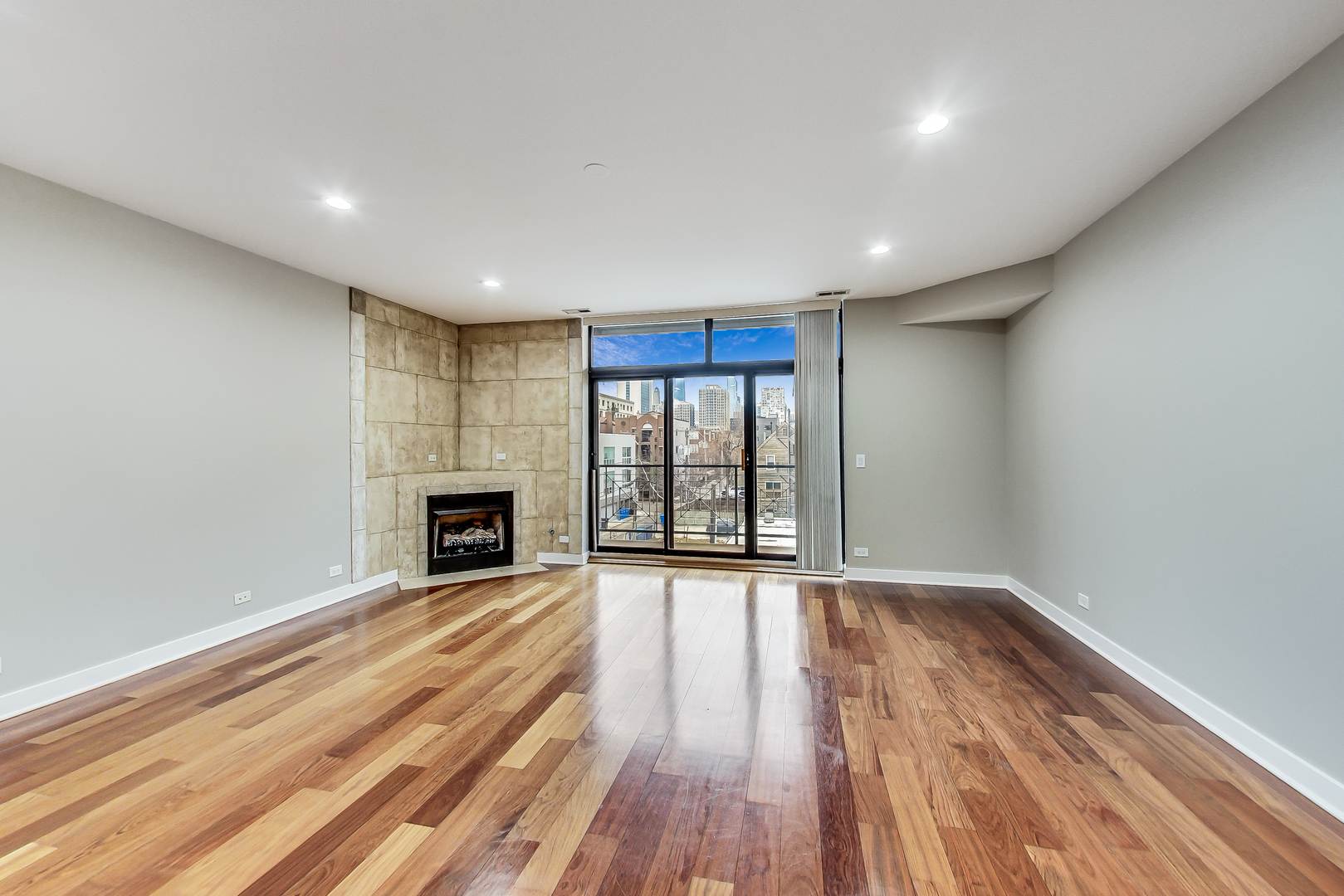 651 North Milwaukee Avenue, Unit 304 Chicago, IL 60642 - Photo 5 of 33 a view of an empty room with wooden floor and a window