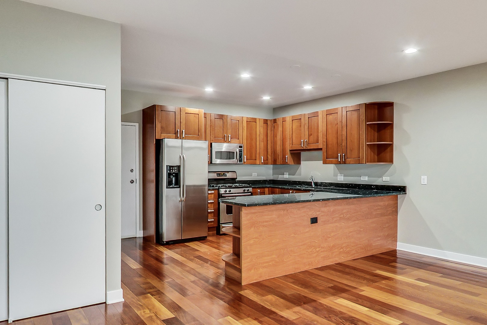 651 North Milwaukee Avenue, Unit 304 Chicago, IL 60642 - Photo 9 of 33 a kitchen with stainless steel appliances granite countertop a refrigerator a sink and a stove