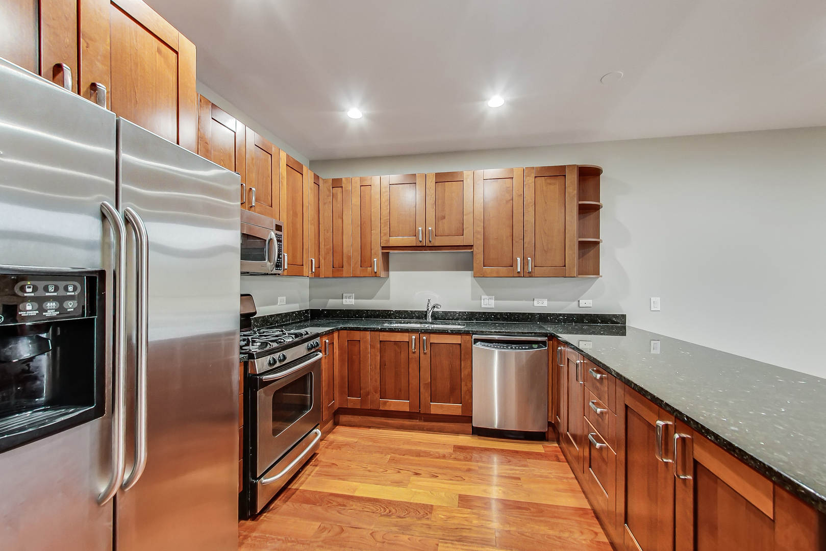 651 North Milwaukee Avenue, Unit 304 Chicago, IL 60642 - Photo 10 of 33 a kitchen with stainless steel appliances granite countertop a sink stove and refrigerator
