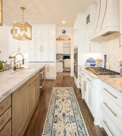 a large kitchen with kitchen island a sink stove and cabinets