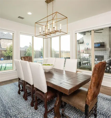 a dining room with furniture a chandelier and wooden floor