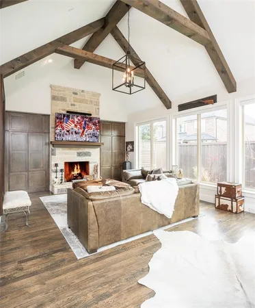a living room with fireplace furniture and a large window