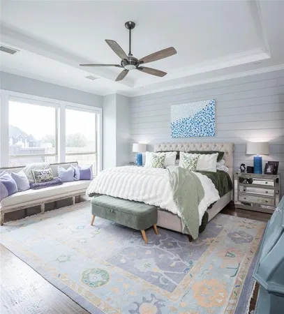 a spacious bedroom with a bed and a large window