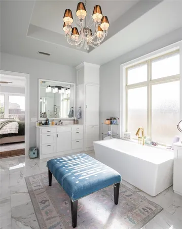a living room with a table chairs and a chandelier