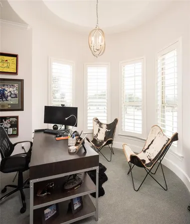 a living room with furniture a flat screen tv and a window