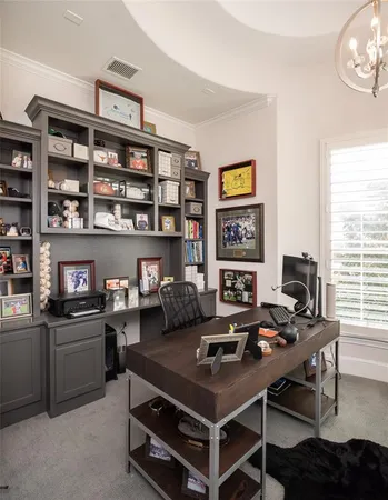 a view of a workspace with furniture and a bookshelf