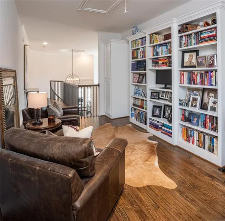 a living room with furniture and a book shelf
