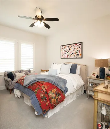 a bed room with furniture and a ceiling fan