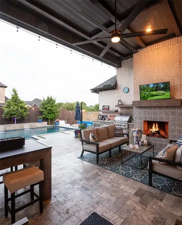 a outdoor living space with furniture and a fireplace