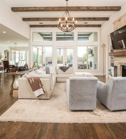 a living room with fireplace furniture and a chandelier
