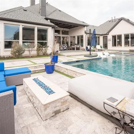 a view of a house with pool and chairs