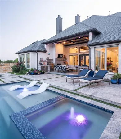 a view of a house with swimming pool and sitting area