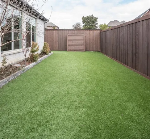 a view of a backyard with wooden fence