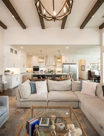a living room with furniture and a view of kitchen