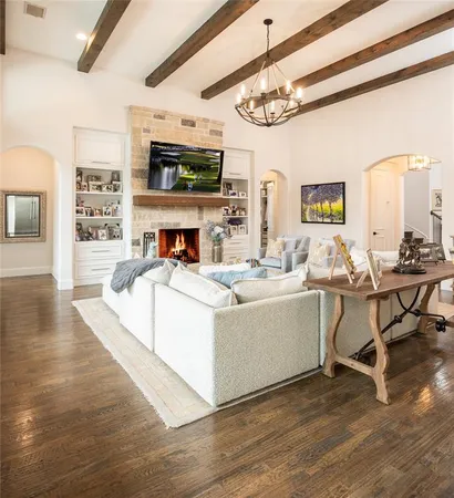 a living room with fireplace furniture and a flat screen tv