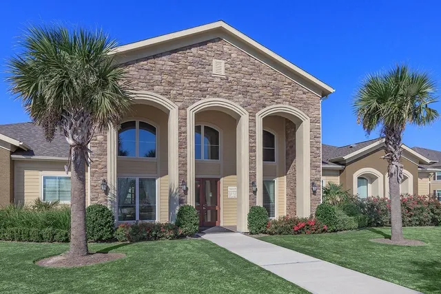 a front view of a house with yard and garage