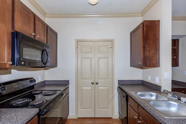 a kitchen with a sink stove and microwave