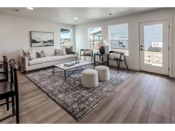 a living room with furniture and wooden floor