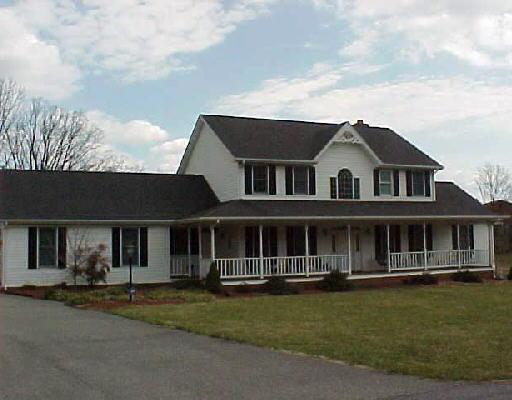 5202 Rosecliff Road Roanoke, VA 24018 - Photo 1 of 4 a front view of a house with a garden