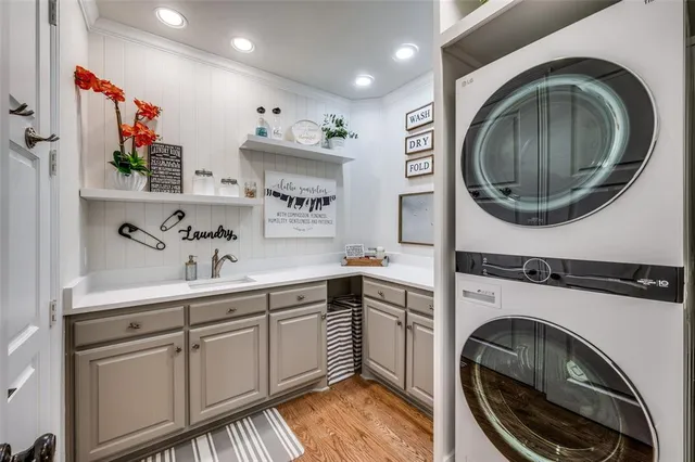 a utility room with sink dryer and washer