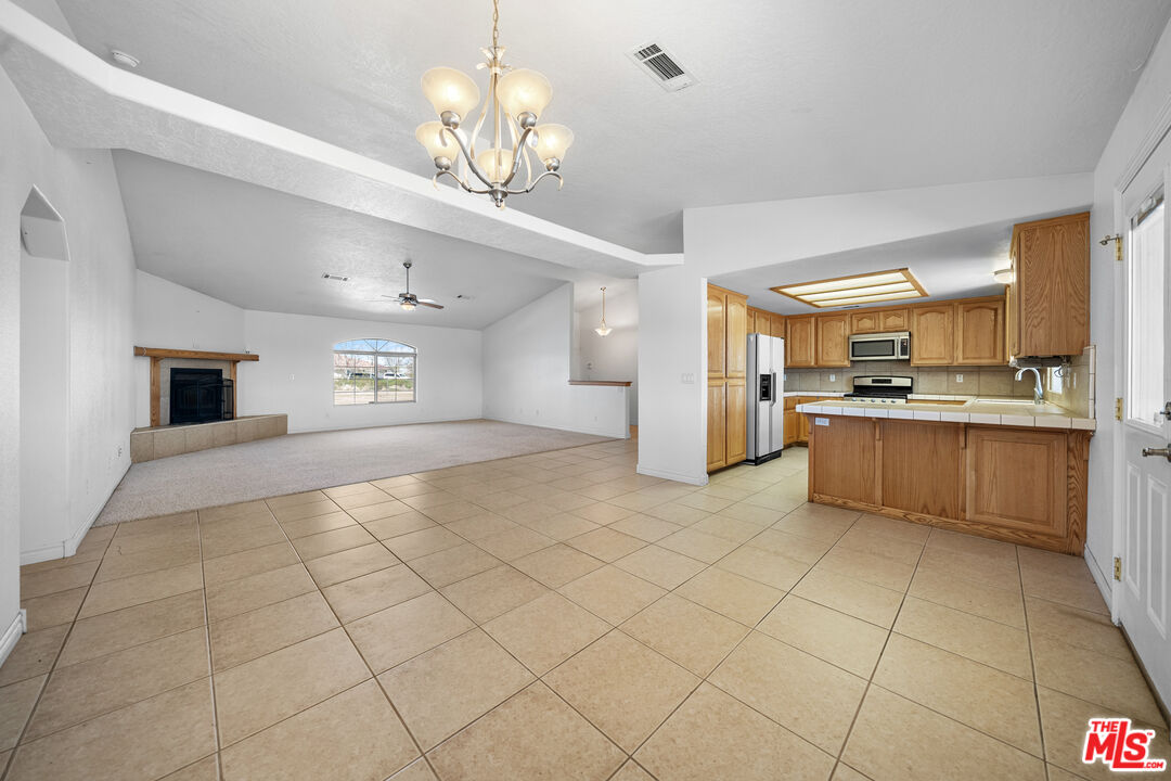 11635 Lebec Road Phelan, CA 92371 - Photo 12 of 35 a large kitchen with cabinets and a stainless steel appliances